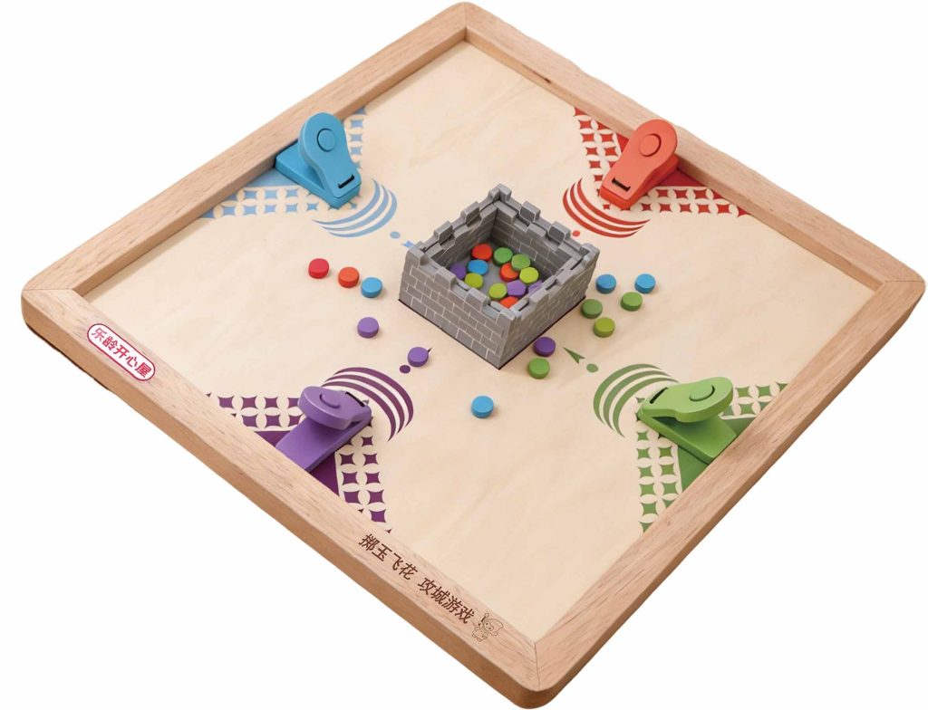 Le Ling Stone Throwing Game board with four spring-loaded launchers and a central castle target.